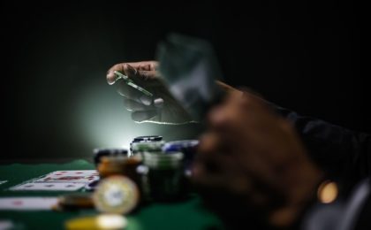 man playing poker holding chips