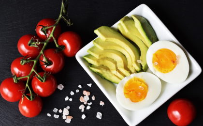 tomato vine and plate of eggs and avocados