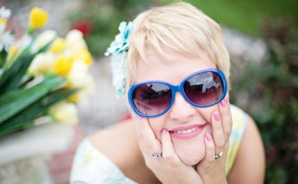 happy woman wearing blue sunglasses